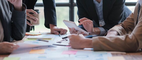 Business People Meeting using laptop computer,calculator,notebook,stock market chart paper for analysis Plans to improve quality next month. Conference Discussion Corporate Concept