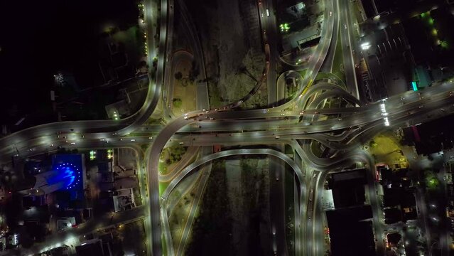 Aerial view above traffic on a intersection, night in Monterrey Obispado, Mexico - top down, drone shot
