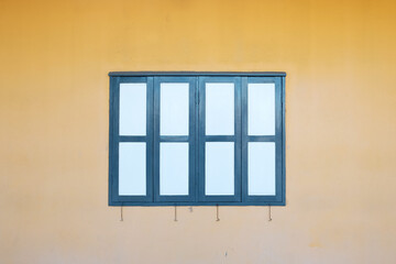 Old window on the yellow wall at thailand