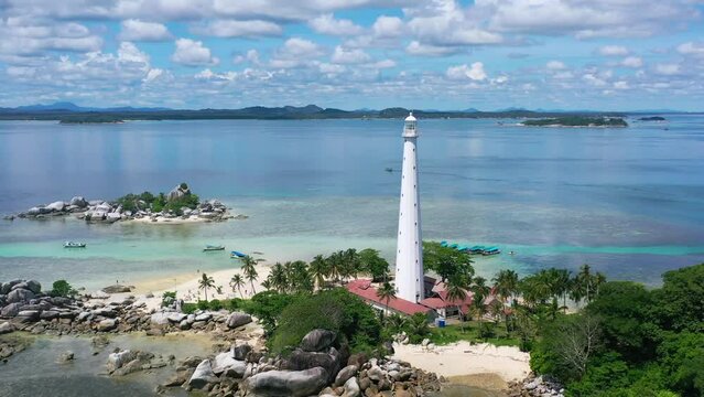 wide aerial of rocky beach on lengkuas island in belitung on sunny summer day