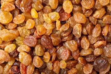 Flat background of raisins. Tasty juicy raisins from grape