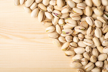 Flat Lay of pistachios on wooden table. Pistachio background, tasty nuts