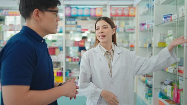 A pharmacist is recommending and explaining a medicine to customers in the pharmacy