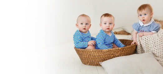 banner with three small children, triplets, copy space Babies in marine costumes