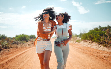 Walking, happy and friends on holiday at a safari during summer together in nature of Kenya. Happy, playful and young African women on vacation in the desert for travel, freedom and adventure - obrazy, fototapety, plakaty