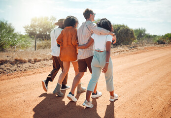 Friends, hug and travel in the countryside for summer vacation walking together on a desert road in...