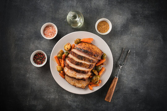 Roasted pork Loin with carrot and broccoli. Grilled sliced Pork Meat