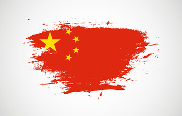 Grunge brush stroke with the national flag of China on a white isolated background