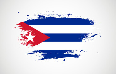 Grunge brush stroke with the national flag of Cuba on a white isolated background