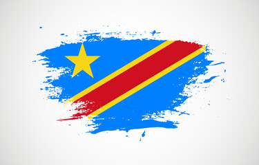 Grunge brush stroke with the national flag of Democratic Republic of the Congo on a white isolated background