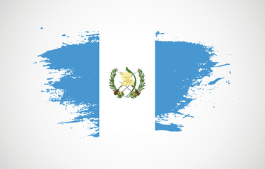 Grunge brush stroke with the national flag of Guatemala on a white isolated background