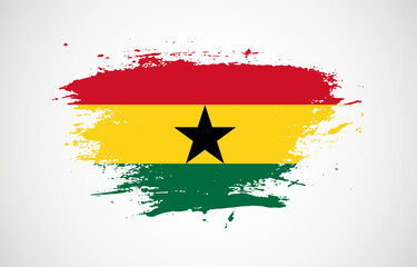 Grunge brush stroke with the national flag of Ghana on a white isolated background