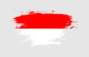 Grunge brush stroke with the national flag of Indonesia on a white isolated background