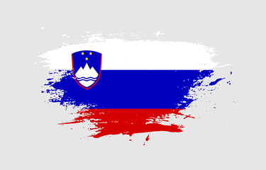 Grunge brush stroke with the national flag of Slovenia on a white isolated background