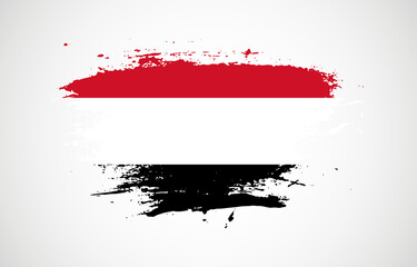 Grunge brush stroke with the national flag of Yemen on a white isolated background