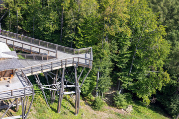 Fototapeta premium Observation tower located at the top of the Slotwiny Arena ski station, leading in the treetops, Krynica Zdroj, Beskid Mountains, Slotwiny, Poland