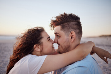 Obraz premium Real couple at beach with nose touching in love, dating and romantic affection. Love, real relationship and funny man and woman by ocean sunset happy, embrace and playful comic on summer holiday