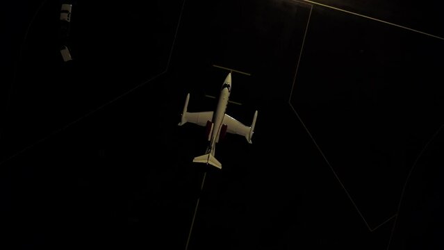 Private business jet starting taxiing for takeoff at night, aerial, Learjet 36A