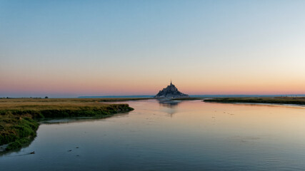 Mont Saint Michel at dawn reflected on the water