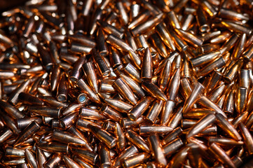 Large caliber copper shells pile for riffle as background