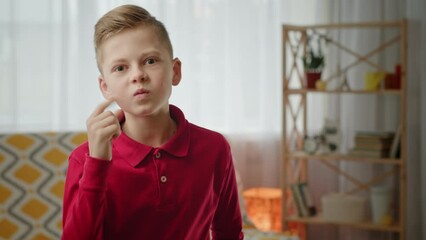 Displeased boy shaking clenched fist