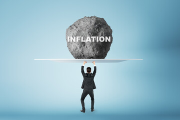 Crisis and anti-crisis management concept with businessman back view holding huge stone with inflation sign above his head, feeling tired on light background - obrazy, fototapety, plakaty