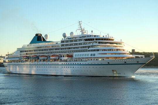 Phoenix cruiseship or cruise ship liner Amera arrival to port Montreal, Canada on sunny day on St. Lawrence River for Indian summer East Coast cruising with downtown skyline, bridge clock tower