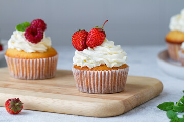 Cupcakes with strawberries and raspberries on the table
