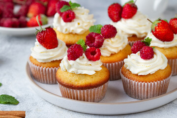 Cupcakes with berries on a plate
