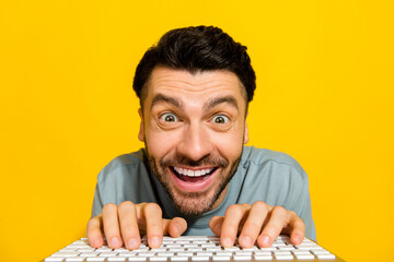 Closeup photo of young nerd geek it worker online distance sitting home watching youtube videos typing keyboard crazy isolated on yellow color background