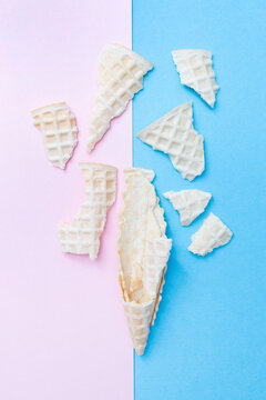 Broken Waffle Cone For Ice Cream On A Pink And Blue Background. Vertical. Top View. Flat Lay.