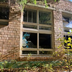 Broken window in a destroyed abandoned building