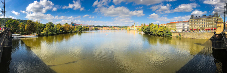 Fototapeta na wymiar photo panorama landscape view of the river Vltava, embankment and buildings along the banks in the center of Prague, Europe