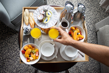 Man having breakfast in a luxury hotel room