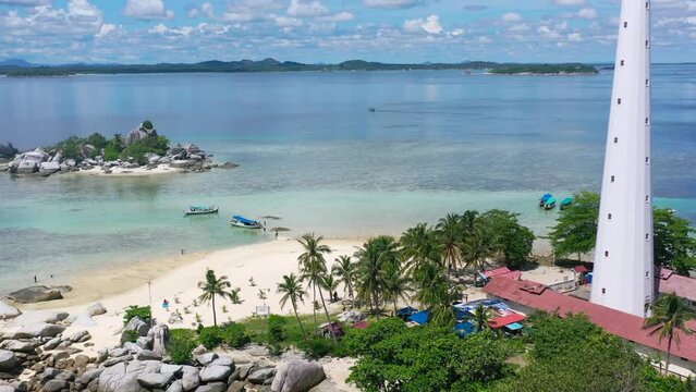 aerial of beautiful white sand beach with tourists visiting lengkuas island in belitung indonesia