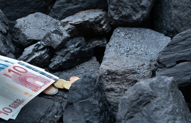 The euro currency against the background of fossil coal.The concept of the energy crisis