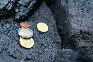  Natural black coal bars for background. Industrial coal nuggets close up.The euro currency against the background of fossil coal.The concept of the energy crisis