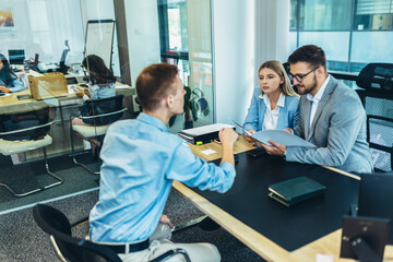 Human resource team talking to a candidate during a job interview in the office.