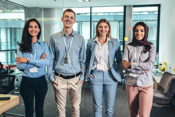 Group of modern multicultural young business women and business man in casual wear in the creative...