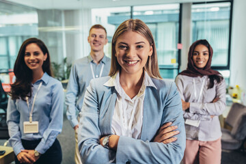 Group of modern multicultural young business women and business man in casual wear in the creative office.