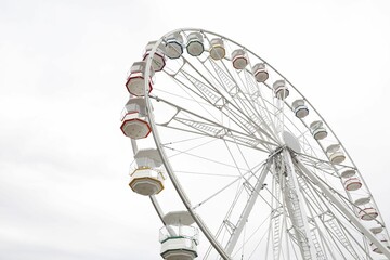 Large white observation wheel against sky, low angle view. Space for text