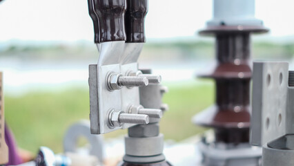 Large copper power cable in section.High voltage power transformer with electrical insulation and electrical equipment in power substation.