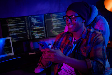 Photo of happy guy sitting chair use telephone chatting evening workplace instagram twitter...