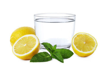 Glass with water, sliced lemon and mint on white background