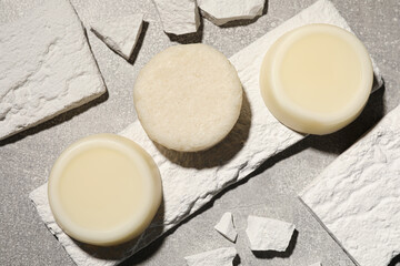 Solid shampoo bars on light grey table, flat lay