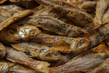 Fototapeta premium Many tasty dried anchovies as background, closeup