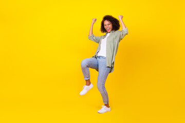 Fototapeta na wymiar Full length photo of nice young lady curly hair celebrate job promotion sales wear trendy khaki look isolated on yellow color background