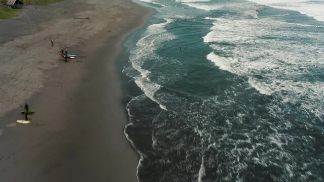 Surfers On The Shore Of El Paredon Beach A Surf Destination Of Guatemala. Aerial Drone Shot