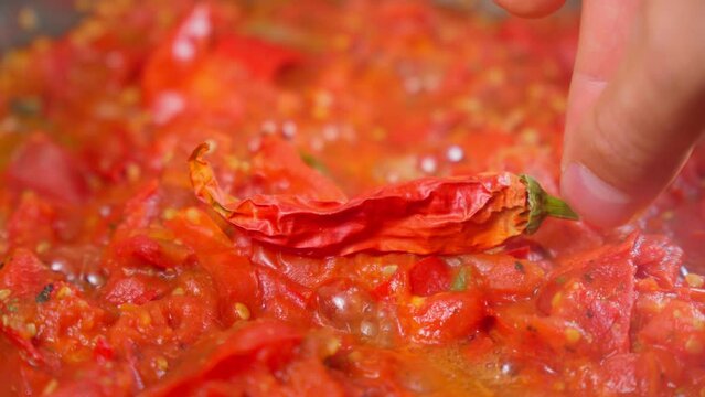 Chili hot sauce made from fermented dry de Cayenne chilies. Concept of cooking tasty hot meal.