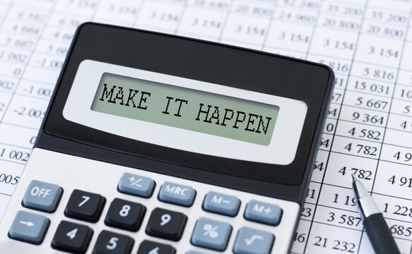 MAKE IT HAPPEN inscription on the screen calculator on the background of financial reports on the table